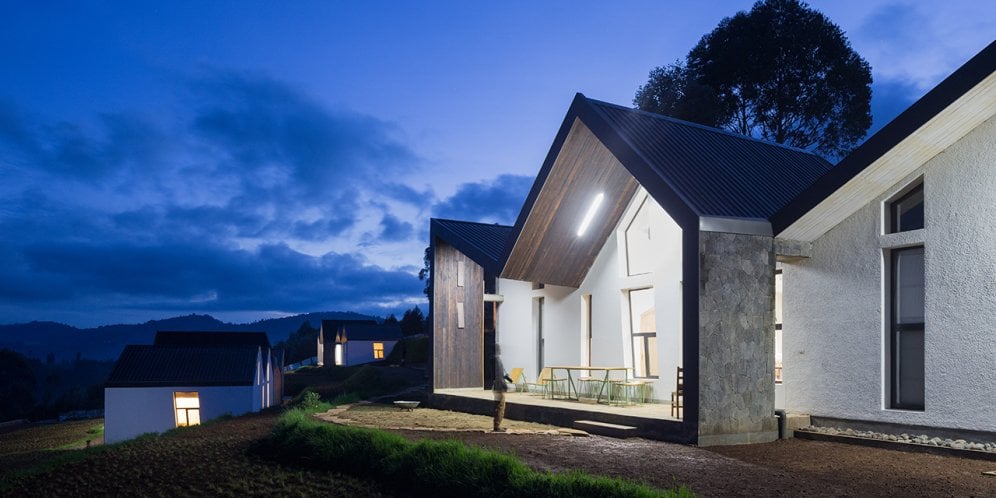 Photo of Butaro Doctors' Sharehousing, Photo by Iwan Baan, Totality of Building Nighttime Exterior of the Housing and Landscape