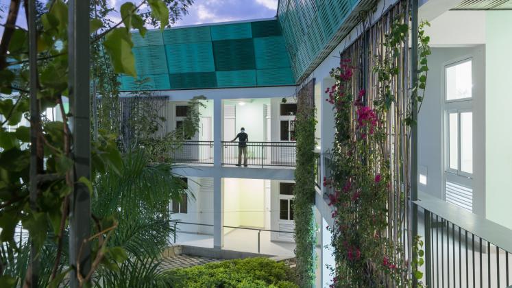 Photo of GHESKIO Tuberculosis Hospital, Photo by Iwan Baan, An evening image of the open-air corridors