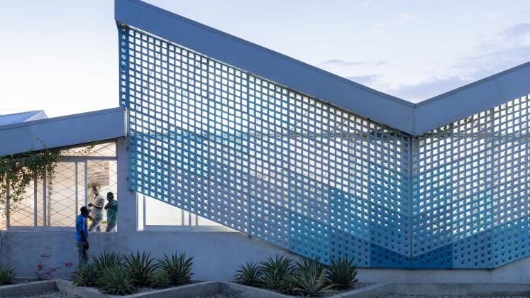 Photo of GHESKIO Cholera Treatment Center, Photo by Iwan Baan, evening photograph of the metal facade