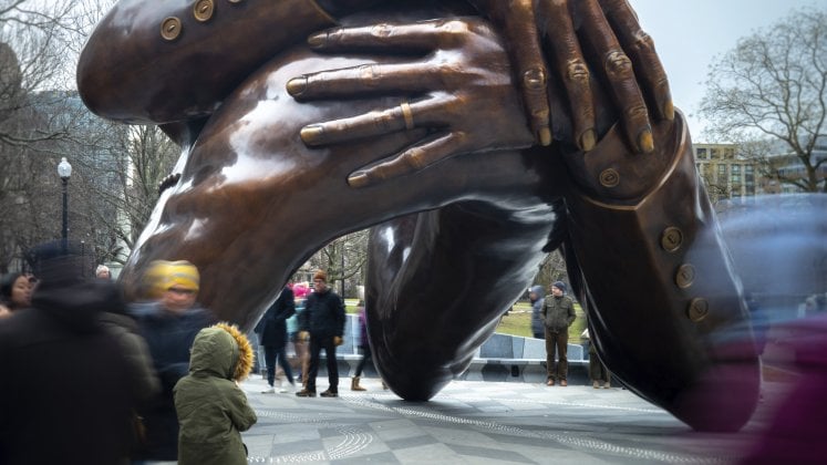 The Embrace. Visitors gather around the Memorial on MLK Day