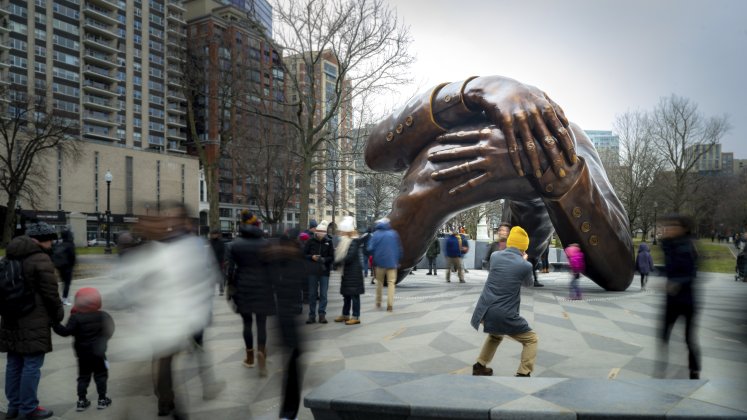 The Embrace. Visitors gather around the Memorial on MLK Day