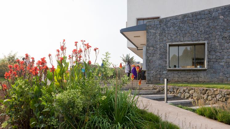 Photo of Butaro District Hospital, Photo by Iwan Baan, View of Gardening in the Butaro Landscape and Masonry Wall