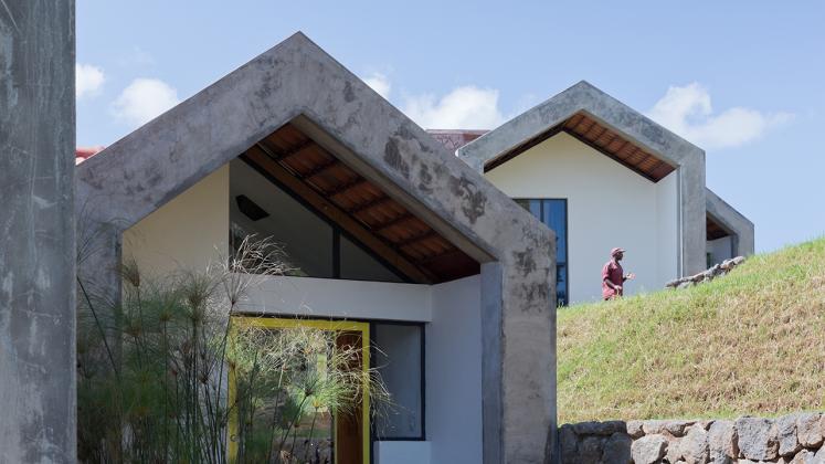 Photo of Butaro Doctors' Housing, Photo by Iwan Baan, Exterior Daytime View of the Hill Side and Multiple Buildings