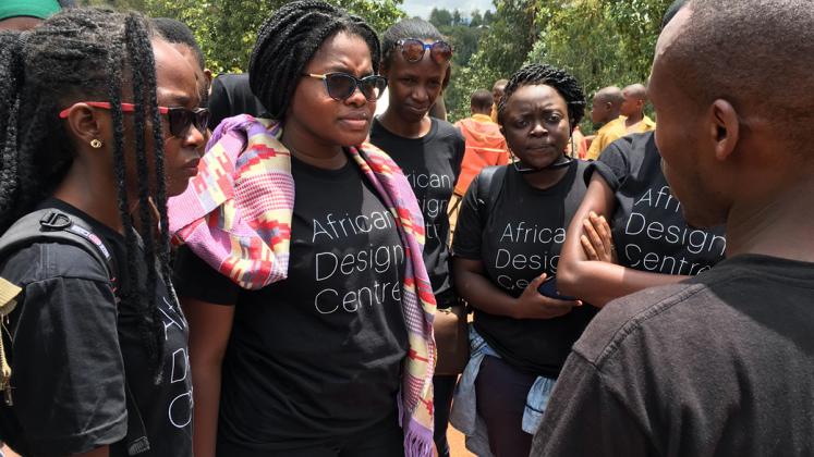 Photo: ADC Fellows on a site visit talk with project manager, Jean Paul Uzabakiriho