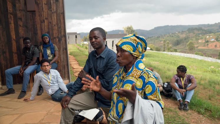 Photo: Butaro stone masons Kankwanze and Hazika advise ADC fellows on best practices for working with local builders on site.