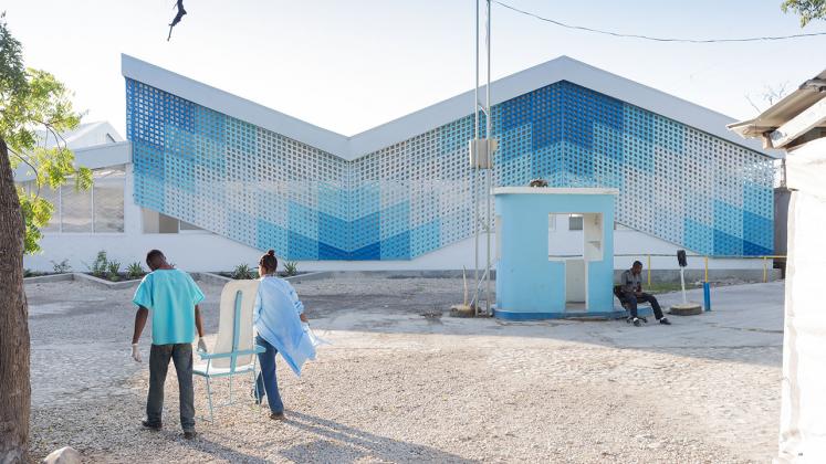 Photo of Gheskio Cholera Treatment Center, Photo by Iwan Baan, Exterior View of Staff Bringing in Custom Furniture