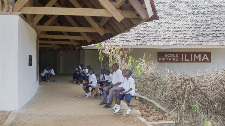 Photo of Ilima Primary School Documentary, Photo of Ilima Priamry school students waiting on outdoor bench