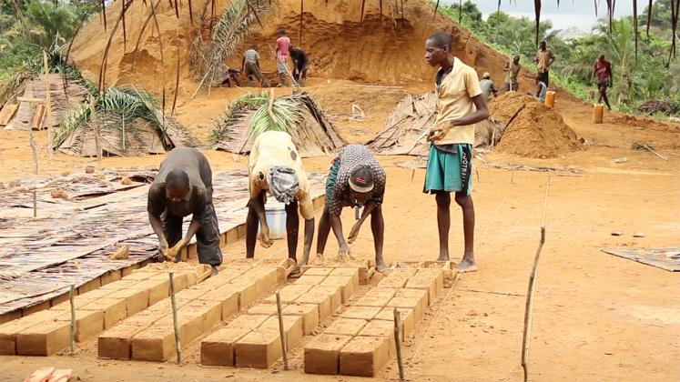 Photo of Ilima Primary School Documentary, Construction wokers laying bricks to sun-bake