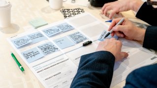 Photo of a person filling out the Impact-based Design Methodology toolkit